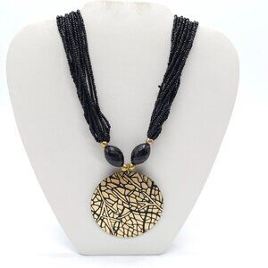 African-Inspired Black Beaded Necklace Gold Textured Pendant Adjustable Chain
